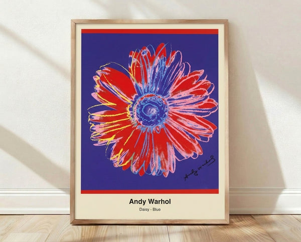 Bold pop art daisy print in vibrant blue, yellow, and white with green stem, inspired by Andy Warhol's iconic flower series.