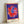 Minimalist pop art daisy design in striking blue and yellow hues with graphic green leaves, contemporary flower print.