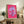 Modern pop art floral poster featuring a luminous pink daisy with bright yellow heart, colorful flower wall art in classic graphic style.