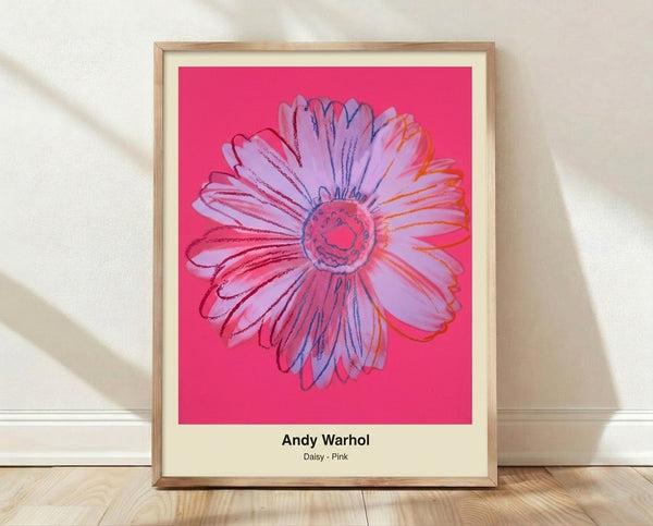 Bold pop art poster featuring a vibrant pink daisy with magenta petals and yellow center on a contrasting black and white background, displaying the whimsical energy of modern flower wall art.