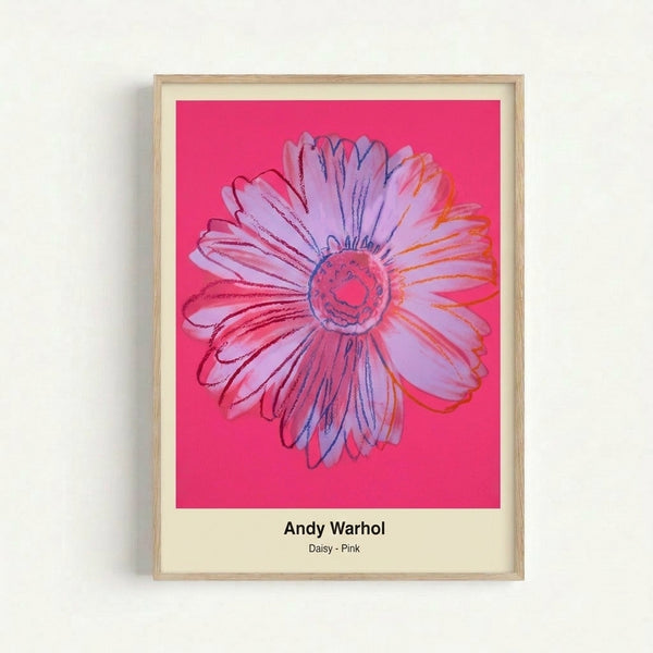 Framed pop art print of a stylized daisy in bright pink and magenta tones with yellow details, rendered in the bold graphic style characteristic of contemporary flower artwork.