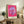 Modern pop art poster of a blooming daisy rendered in hot pink and magenta with bold graphic elements and a playful, vibrant aesthetic.