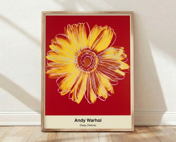 Bold pop art daisy print with vibrant yellow petals, bright green stem, and pink accents on white background, displayed as a framed poster.