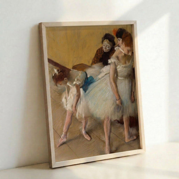 Framed wall art depicting graceful dancers in a contemplative examination scene, rendered in subtle colors and refined brushwork characteristic of classical ballet imagery.