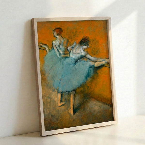 Framed art print showing multiple ballerinas in various poses at the practice barre, featuring soft pinks, greens, and beiges in a refined vintage aesthetic.