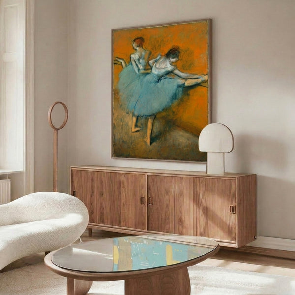Wall art featuring ballet dancers in motion at the barre, displayed in a framed print with muted pastel colors and timeless classical composition.