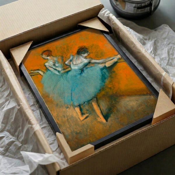 Vintage-style framed poster depicting graceful ballerinas at the practice barre in soft neutral and muted color tones, evoking classical dance refinement.
