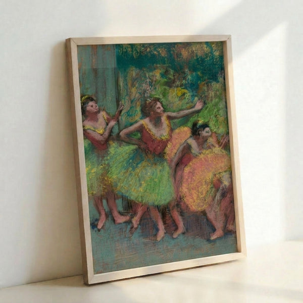 Framed art print of classical dancers in soft watercolor, with warm ochre and pale blue tones creating an elegant, timeless aesthetic.