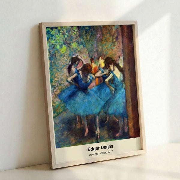 Framed poster of elegant ballerinas rendered in pale blues and creams with impressionist technique, conveying fluid movement and the intimate atmosphere of rehearsal.