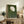 Peaceful nature-inspired framed poster of a dandelion seed head rendered in muted sage green and cream, creating a meditative wall display.