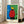 Surrealist poster displaying Miro's playful composition: abstract biomorphic shapes in red, blue, yellow, and black arranged around a luminous sun motif.