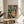 Framed artwork depicting a stylized figure integrated into an ornamental setting, dominated by expressive color and decorative pattern elements.