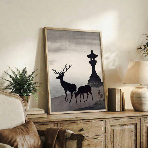 Minimalist Japanese-inspired framed artwork with a contemplative deer, traditional lantern, and mountainous backdrop in charcoal and cream tones.