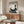Zen-style wall art depicting a tranquil fawn and stone lantern composition rendered in monochromatic black and cream Japanese artistic tradition.