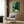 Serene framed nature print with minimalist turtle illustration amid landscape elements in soft sage, dark green, and warm tan tones reflecting Japandi design philosophy.