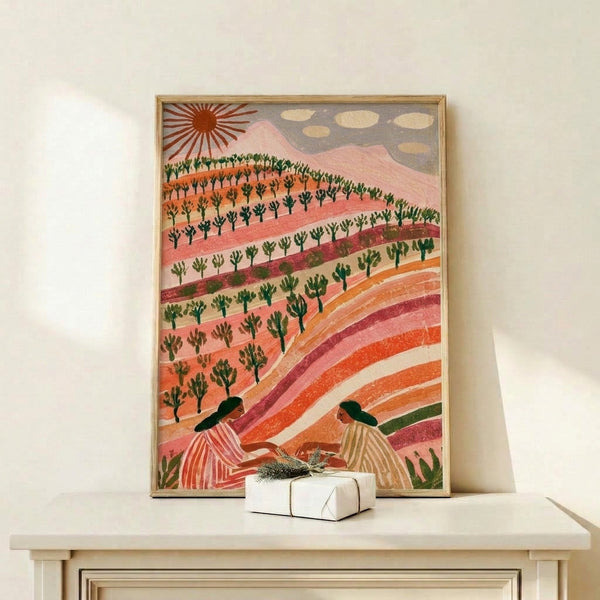 Warm pastoral art print on wall showing rolling hillsides with layered fields, a glowing sun, botanical elements, and a figure in earthy cream and forest green hues with whimsical boho aesthetic.