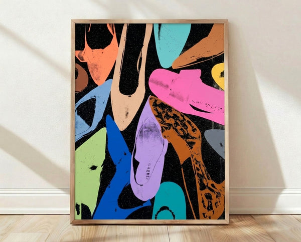 Pop art poster of diamond dust shoes in vibrant jewel tones with shimmering metallic accents, framed on a wall.