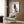 Pop art wall print featuring a dapper Italian Greyhound in an oversized sweater, executed in warm rust and brown hues with cream accents and humorous flair.
