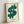 Framed pop art poster with a striking green dollar symbol against dark background, minimalist Bauhaus design evoking 1960s commercial satire.