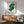 Framed modern art poster featuring an iconic dollar sign rendered in vibrant green and white, pop art Bauhaus aesthetic with subversive commercial message.