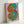 Wall art displaying a simplified, colorful dollar design in bold flat tones, exemplifying contemporary pop art style and visual impact.