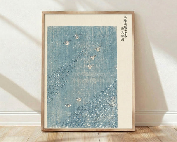 Japanese woodblock print featuring dotterel birds in a flowing stream surrounded by rocks, rendered in pale blue, teal, and cream tones with serene, contemplative mood.