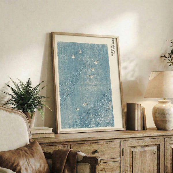 Japanese Ukiyo-e style art print of birds gathered in a stream with rocks, palette of pale blue, white, and charcoal gray creating harmony with nature.