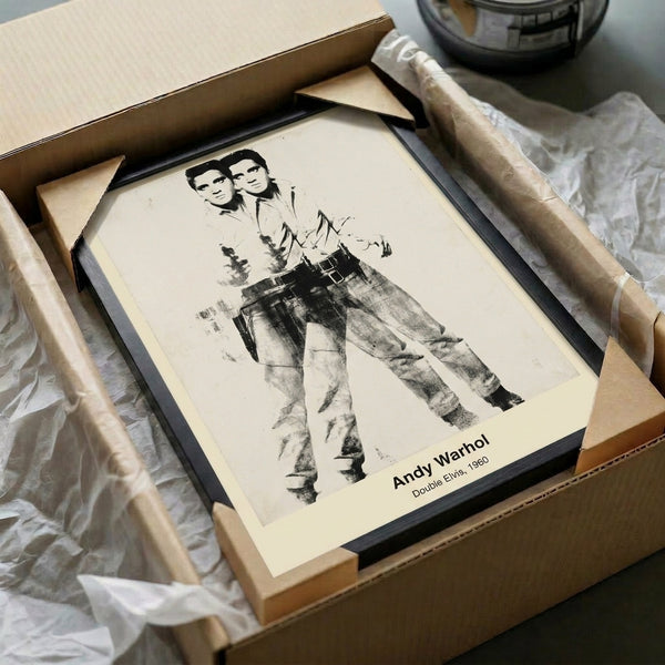 Bold pop art print with two identical portraits in silver and black tones, embodying modern celebrity icon imagery on a gallery wall.