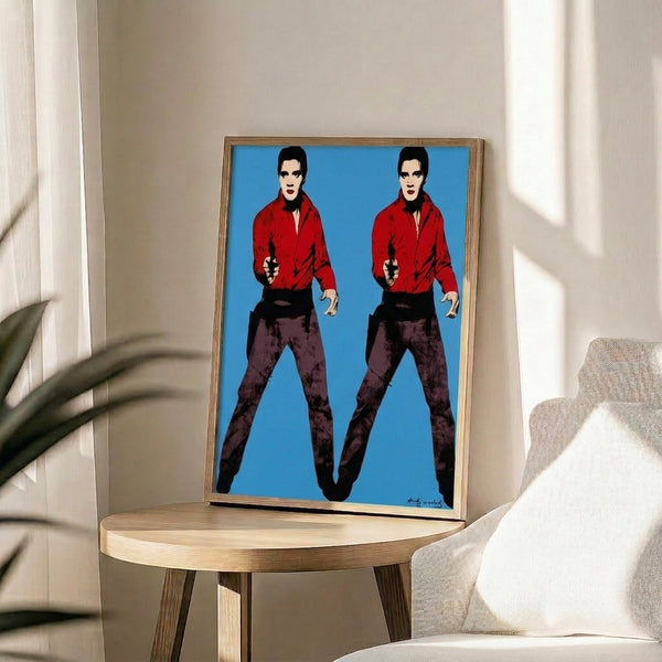 Framed pop art print of doubled Elvis figures rendered in Warhol's iconic silkscreen style with vivid complementary colors and minimalist form.