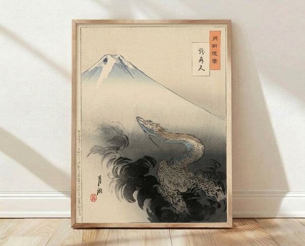 Traditional Japanese woodblock print featuring a majestic dragon coiling around Mount Fuji, rendered in cream, blue-green, and charcoal tones with rust accents, framed and displayed on a wall.