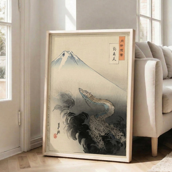 Framed Japanese woodblock art presenting Mount Fuji as a majestic focal point with an ornamental dragon, featuring cream and charcoal gray with blue-green and rust orange accents.