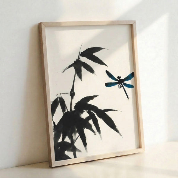 Framed ink wash artwork showing a graceful dragonfly among bamboo shoots and foliage in black, cream, and teal tones with minimalist aesthetic.