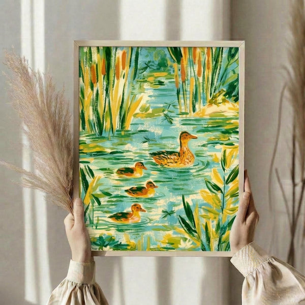 Cottagecore watercolor illustration of ducks floating on calm water among cattails and lily pads in soft sage green and cream tones, framed on a wall.