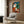 Framed modernist poster with surrealist dreamscape composition in warm ochres, creams, and vibrant contrasting colors.