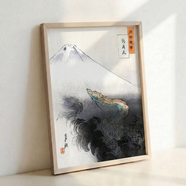 Contemplative Japanese woodblock print on wall showing Mount Fuji silhouetted against waves with an eagle, executed in charcoal gray, tan, and calming blue-green palette.