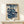 Japandi-style framed poster of a poised geisha in traditional kimono rendered in indigo and coral tones, accompanied by a smaller figure among cherry blossoms, evoking nostalgic cultural elegance.