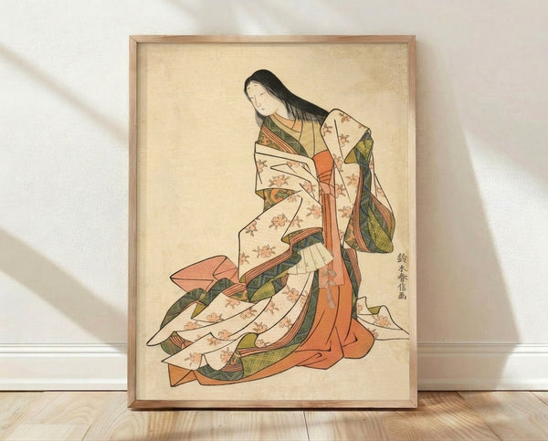 Framed Japanese woodblock print depicting an elegant woman in an ornate kimono with flowing fabric, adorned with coral and olive green floral motifs against a cream background.