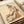 Ornamental ukiyo-e style print capturing the refined beauty of a kimono-clad figure surrounded by botanical designs in cream, coral, olive, and black tones.