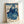 Traditional Japanese woodblock print showcasing a graceful geisha in ornate indigo kimono with fan, featuring botanical elements and birds in a classical aesthetic.