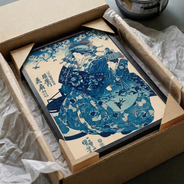 Classical framed Japanese woodblock print depicting a refined geisha in indigo and navy kimono with decorative fan, accompanied by birds and botanical flourishes.