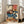 Edo-inspired woodblock print with dramatic narrative between two figures in interior space, cream and indigo dominant with red-orange accents and yellow-gold highlights.