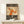 Angular figure study in vintage Bauhaus design with wire-like linework and expressive hands against cream background with burnt orange and charcoal accents; gallery poster art.