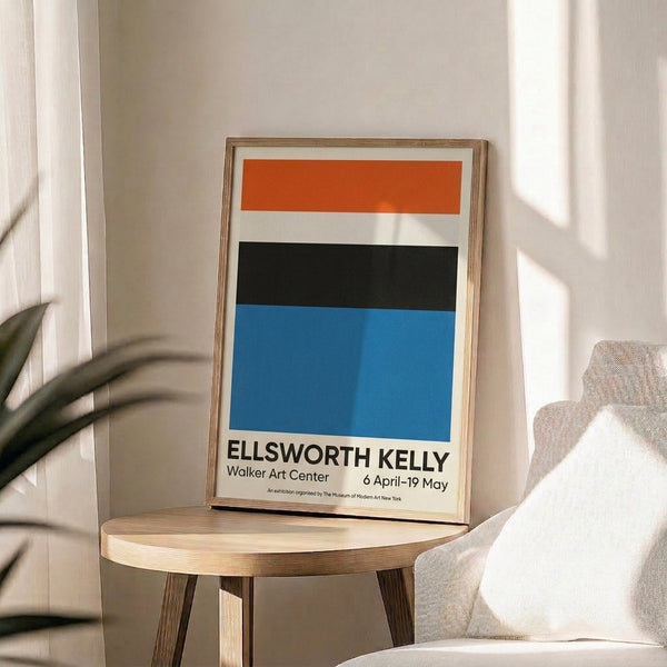 Calm, contemplative poster art with simple blue and orange geometric shapes on neutral background, framed on wall.