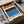 Minimalist modern poster displaying abstract geometric composition in warm orange tones with black and blue accents.