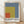 Framed minimalist poster print featuring bold geometric rectangles in slate blue, golden yellow, rust red, and cream, inspired by Bauhaus color field principles.