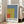 Minimalist wall art featuring color field composition with intersecting rectangles rendered in restrained palette of slate blue, golden yellow, deep rust, and cream.