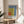 Contemporary geometric poster print in Bauhaus aesthetic with rectangles of contrasting colors—blue, rust red, golden yellow, and cream—arranged with systematic precision.