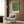 Modern line art poster of an organized, welcoming entryway featuring a dog, suitcase, succulent, and household items in sage green, cream, and warm accent colors.