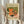 Warm and inviting mid-century modern poster depicting a classic moka pot coffee maker surrounded by a coffee cup, orange segments, and leaves in nostalgic burnt orange and sage green hues.