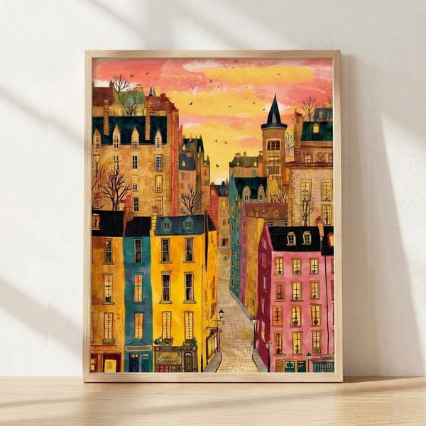 Watercolor street scene depicting an old town with warm coral and golden yellow buildings, a distant castle tower, and teal sky with flying birds, framed on a wall in a whimsical folk art style.